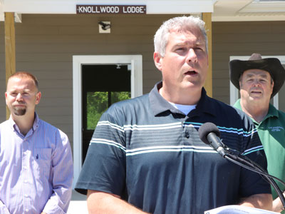 Photo of County Exec in front of Lodge